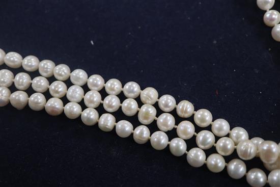 A triple strand freshwater? pearl necklace with white gold and diamond cluster set clasp, 68cm.